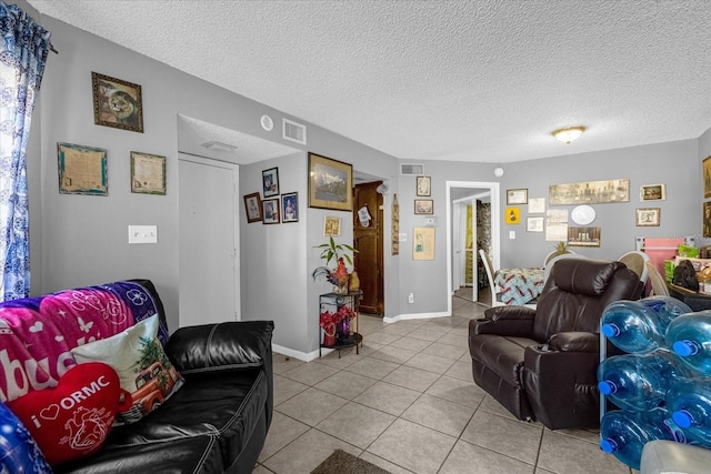 tiled living room with a textured ceiling