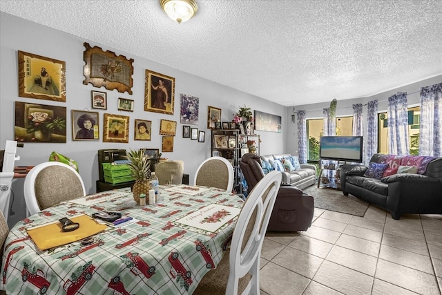 dining area featuring a textured ceiling and light tile patterned floors