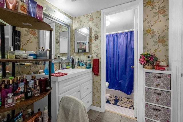 bathroom featuring toilet, tile patterned floors, walk in shower, and vanity