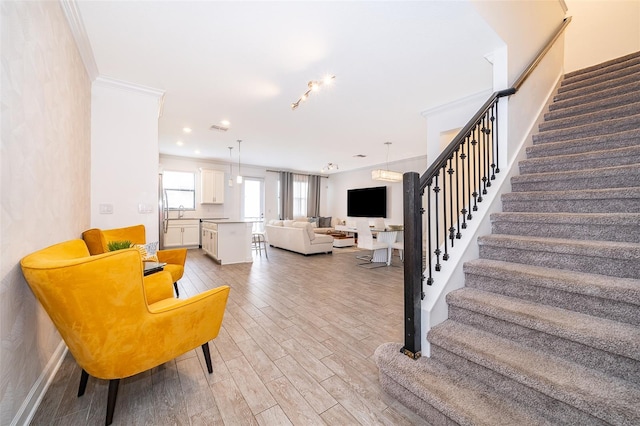 living room featuring hardwood / wood-style floors and ornamental molding