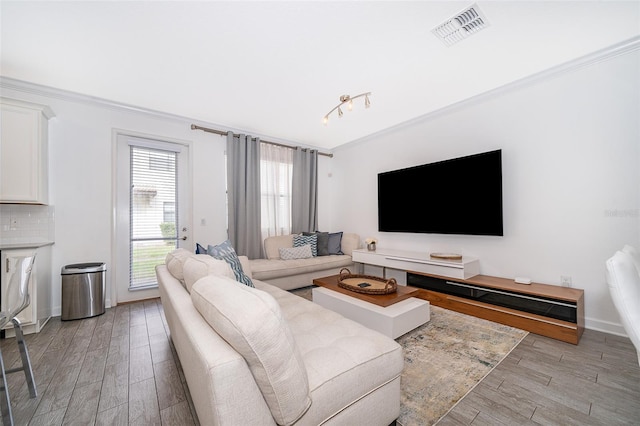 living room featuring ornamental molding and light hardwood / wood-style floors