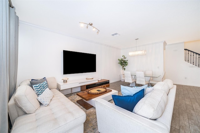 living room featuring hardwood / wood-style flooring and ornamental molding