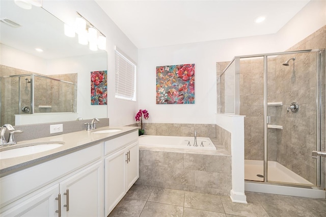 bathroom featuring tile patterned flooring, shower with separate bathtub, and vanity