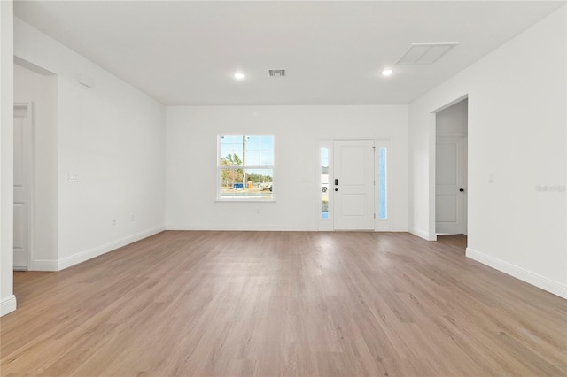 foyer with light wood-type flooring, baseboards, visible vents, and recessed lighting