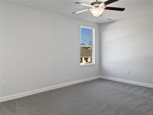 spare room with ceiling fan and carpet