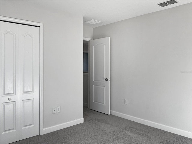 unfurnished bedroom featuring a closet and carpet