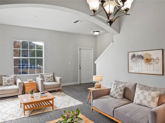 carpeted living room featuring a chandelier