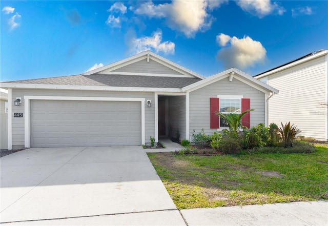 ranch-style home featuring a garage and a front lawn