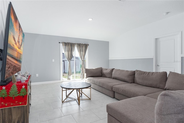 living room featuring light tile patterned floors and vaulted ceiling