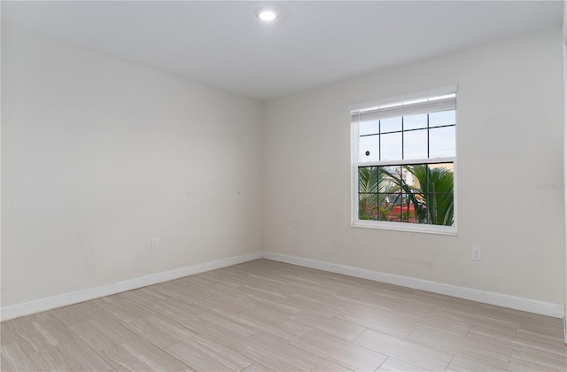 empty room with light hardwood / wood-style flooring