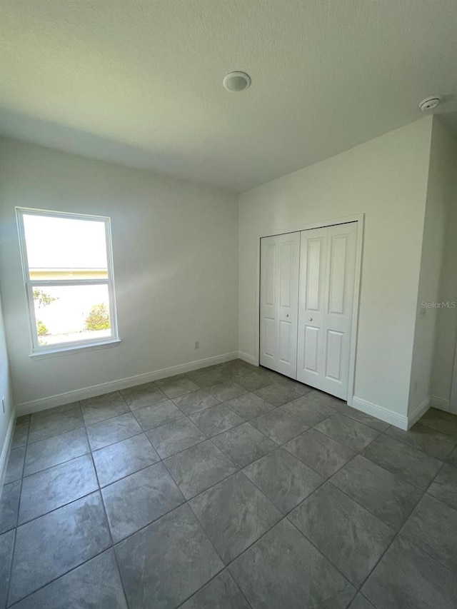 unfurnished bedroom featuring a closet