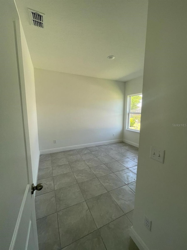 unfurnished room with light tile patterned floors