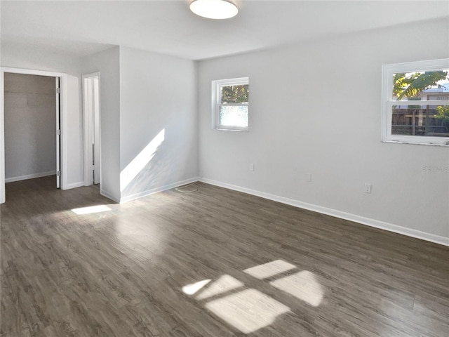 spare room with dark wood-type flooring