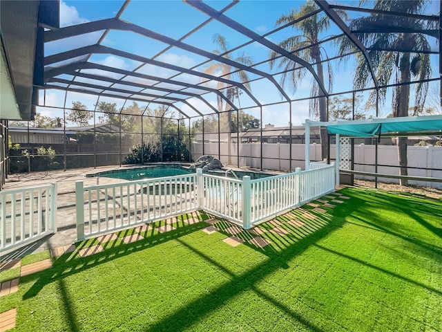 view of pool featuring a patio, glass enclosure, and a yard