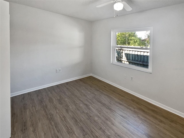 spare room with a textured ceiling, ceiling fan, and dark hardwood / wood-style flooring