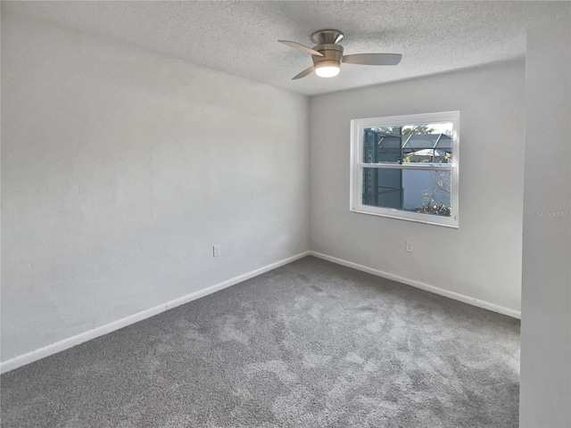 empty room featuring a textured ceiling, ceiling fan, and carpet