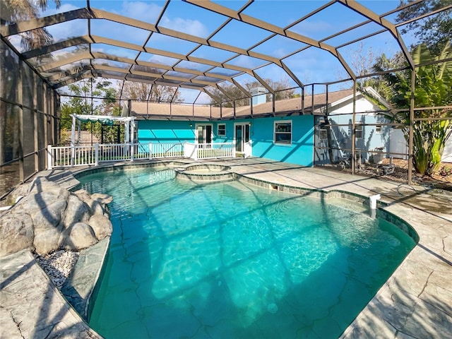 view of pool with a lanai, an in ground hot tub, and a patio area