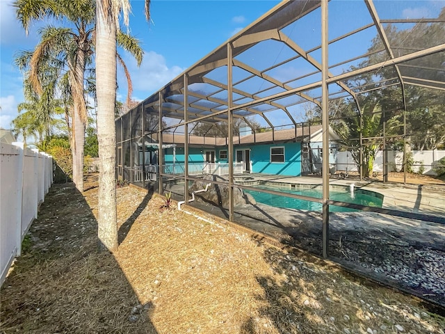 view of pool with a patio area and glass enclosure