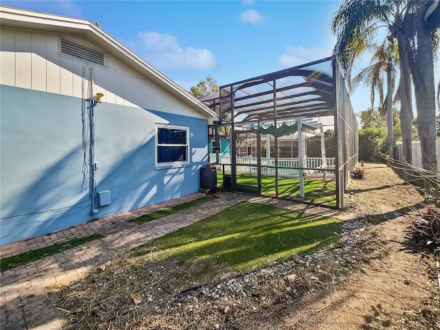 view of yard featuring glass enclosure