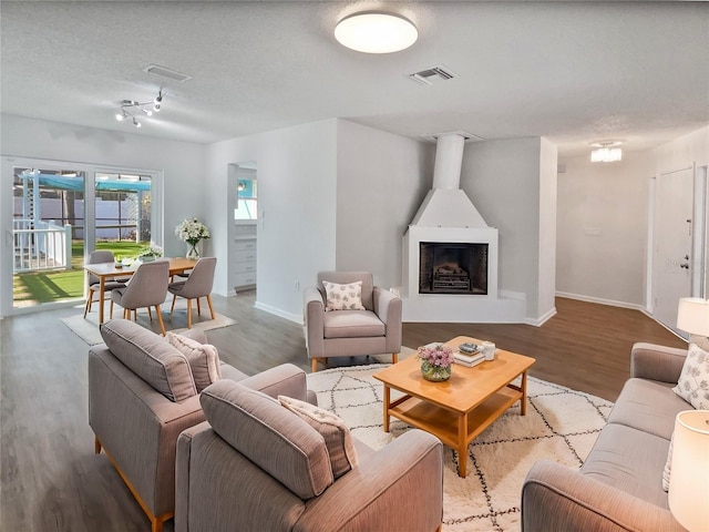 living room featuring a textured ceiling and hardwood / wood-style flooring