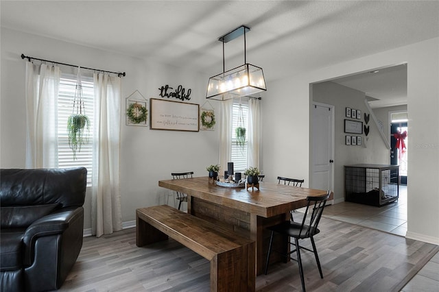 dining area with plenty of natural light and hardwood / wood-style flooring