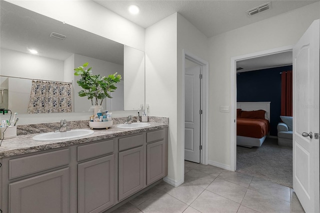 bathroom with tile patterned floors and vanity