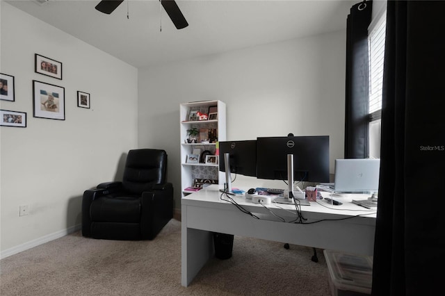 home office with ceiling fan and light carpet