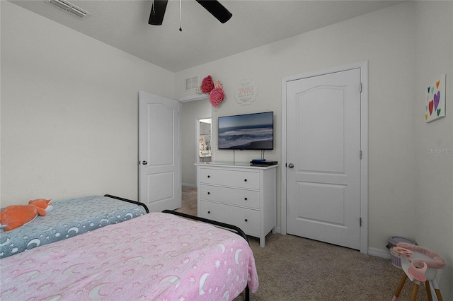 bedroom with ceiling fan and light carpet