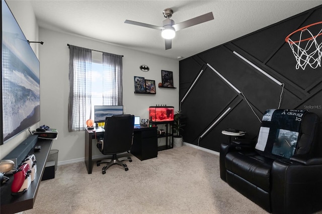 carpeted office space with ceiling fan and a textured ceiling