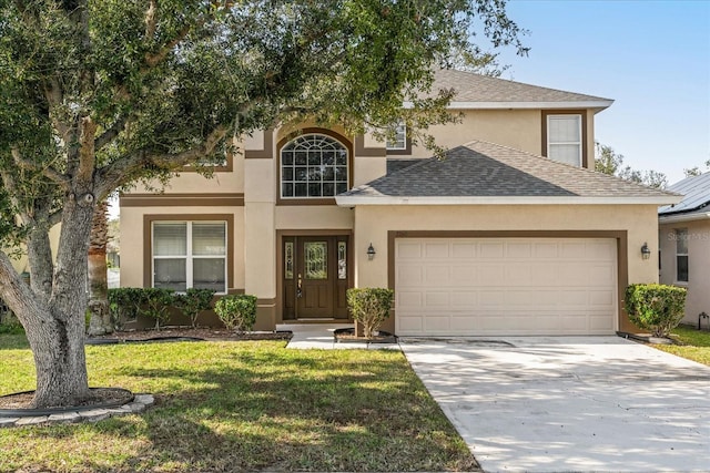 view of front of home featuring a garage and a front yard