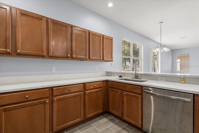 kitchen featuring sink, an inviting chandelier, dishwasher, light stone counters, and pendant lighting