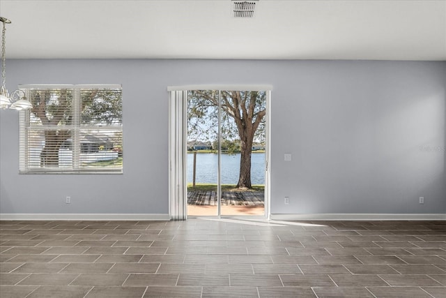 empty room featuring a water view