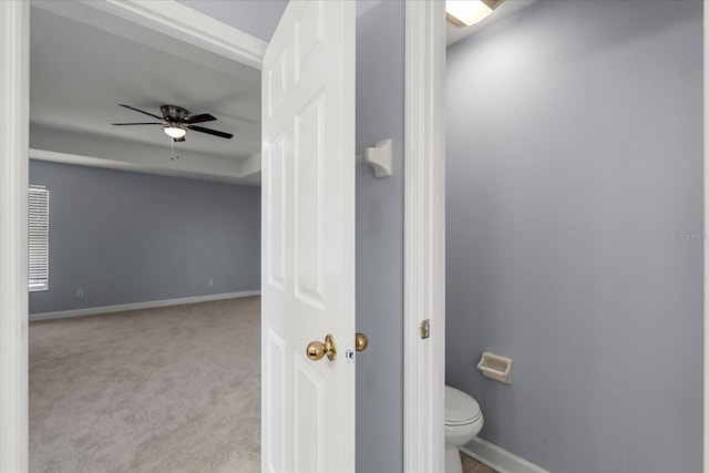 bathroom featuring toilet and ceiling fan