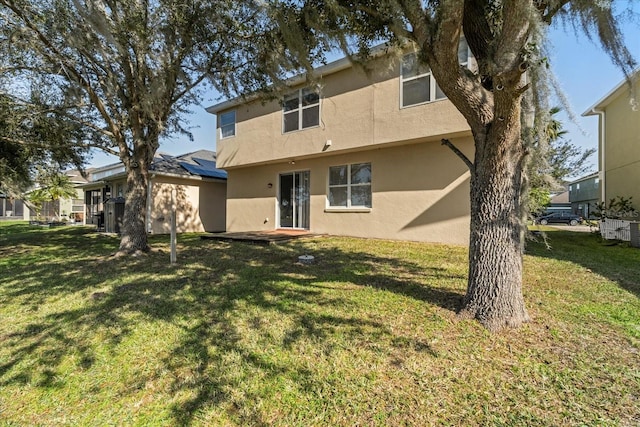 rear view of property featuring a yard