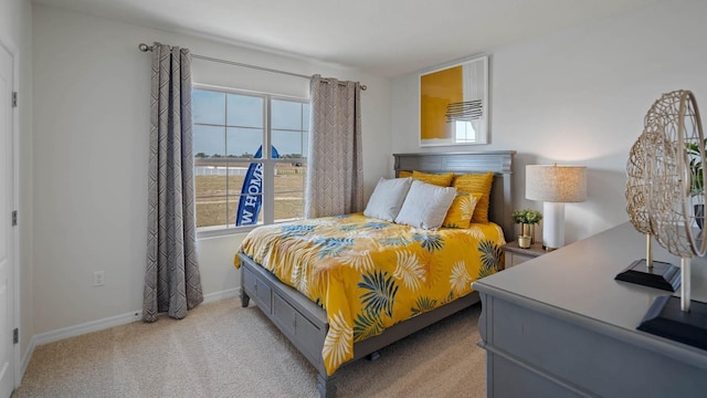 bedroom with light colored carpet and multiple windows