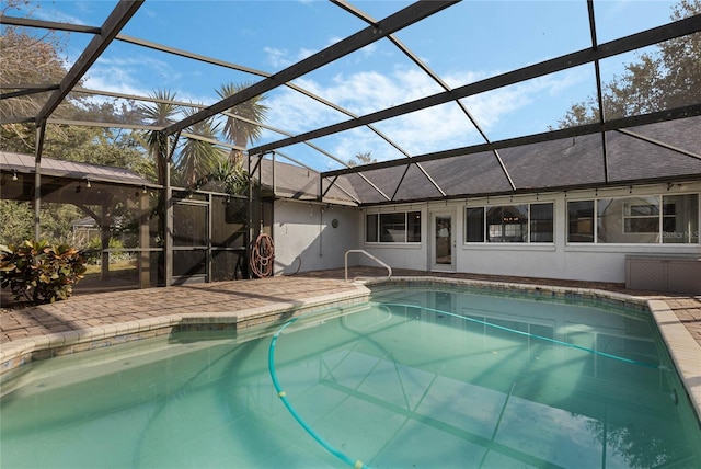 view of pool featuring glass enclosure