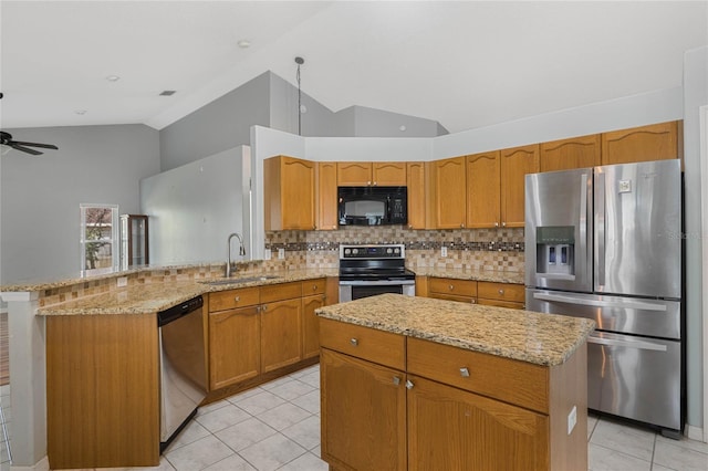 kitchen with appliances with stainless steel finishes, a center island, decorative backsplash, sink, and vaulted ceiling