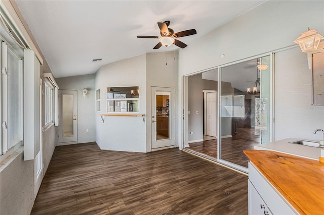 unfurnished living room featuring ceiling fan, lofted ceiling, dark hardwood / wood-style floors, and sink