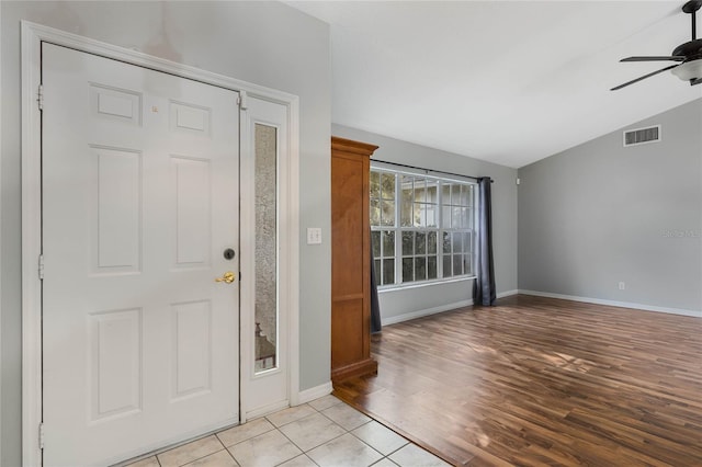 entrance foyer with vaulted ceiling, ceiling fan, and light tile patterned floors