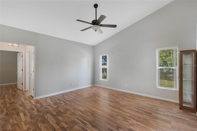 spare room featuring ceiling fan, wood-type flooring, and high vaulted ceiling