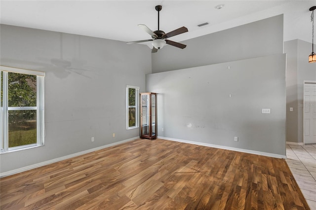 unfurnished room with ceiling fan and wood-type flooring