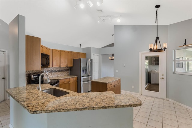 kitchen with appliances with stainless steel finishes, lofted ceiling, hanging light fixtures, kitchen peninsula, and light tile patterned flooring