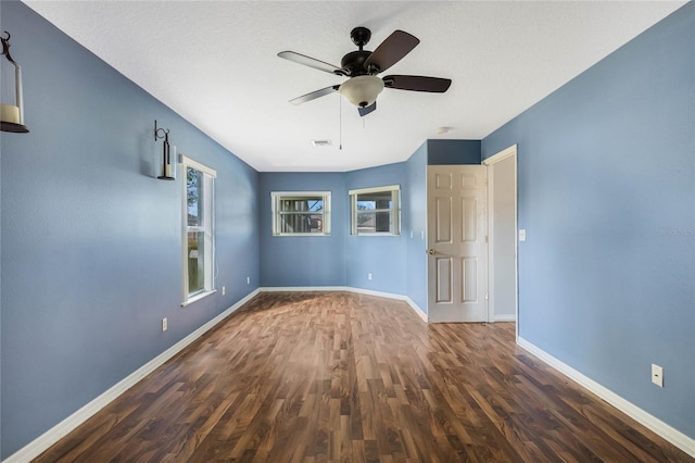 empty room featuring ceiling fan and dark hardwood / wood-style floors