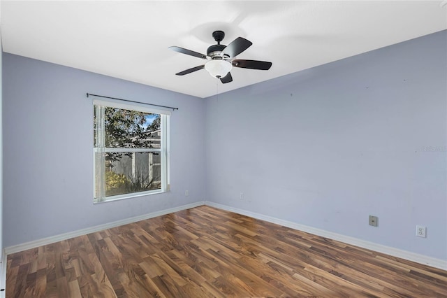 unfurnished room with ceiling fan and dark wood-type flooring