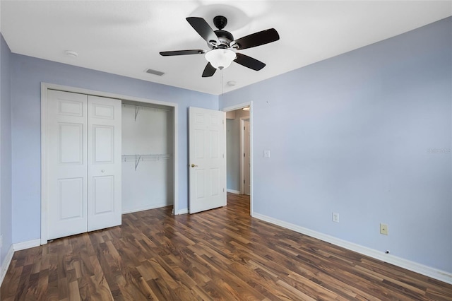 unfurnished bedroom with ceiling fan, a closet, and dark hardwood / wood-style flooring