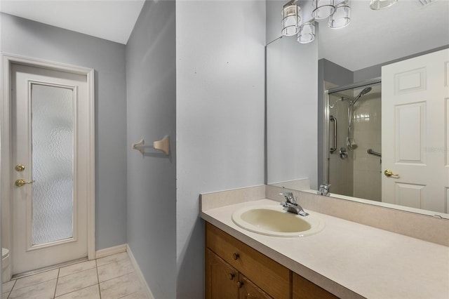 bathroom with vanity, tile patterned floors, and a shower with door