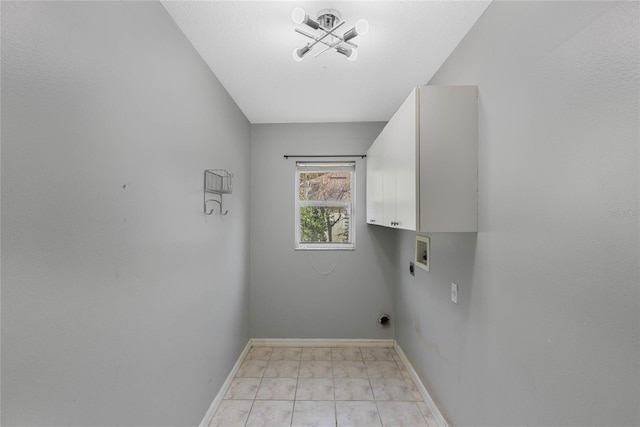 clothes washing area with cabinets and hookup for a washing machine