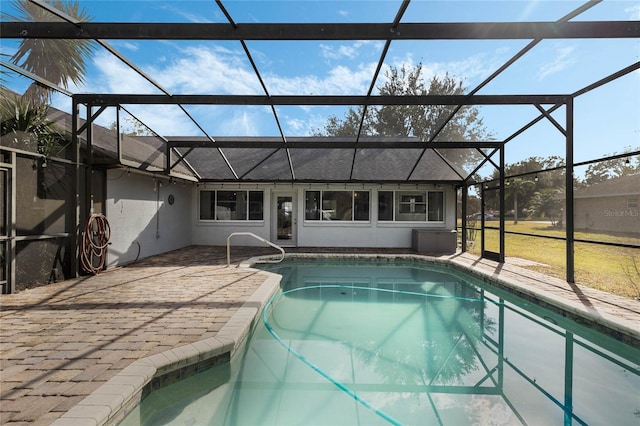 view of swimming pool featuring a lanai