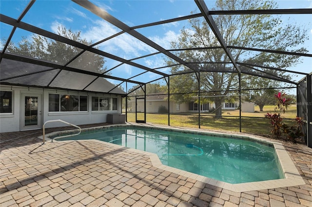 view of swimming pool with a lanai and a patio area