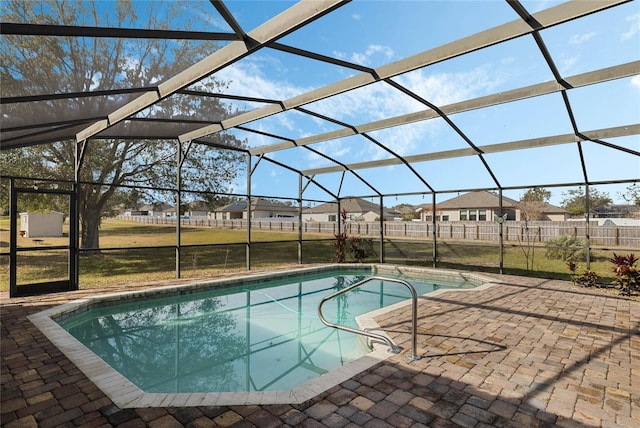 view of swimming pool featuring a lanai, a lawn, and a patio